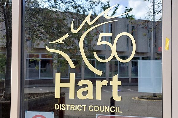 Door to Hart District Council Offices in Fleet, showing the council's logo